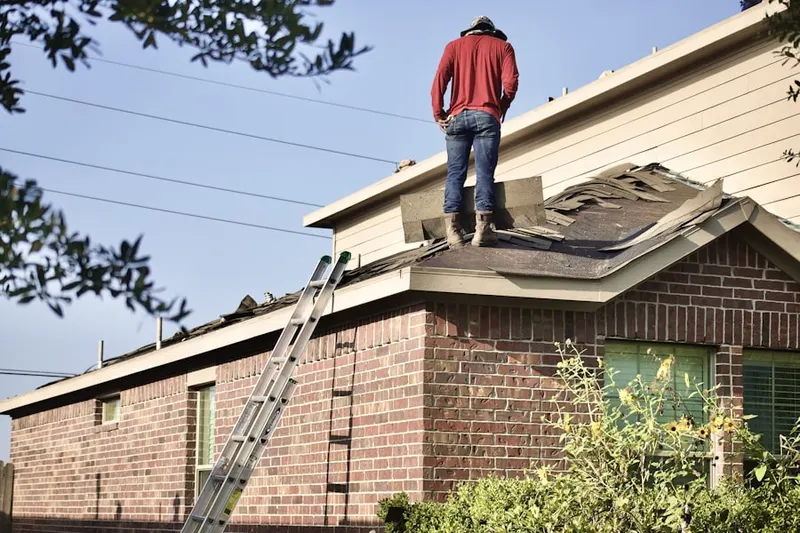Professional roofer working on a residential roof in Grassland